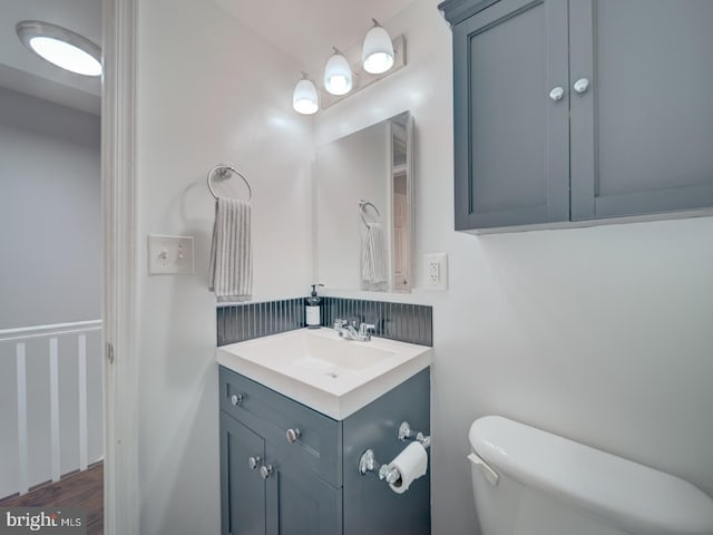 bathroom featuring vanity and toilet