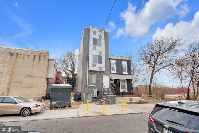 townhome / multi-family property with brick siding