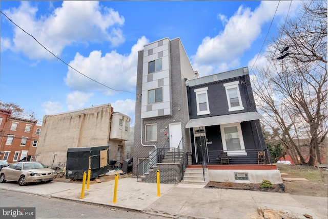 townhome / multi-family property with brick siding