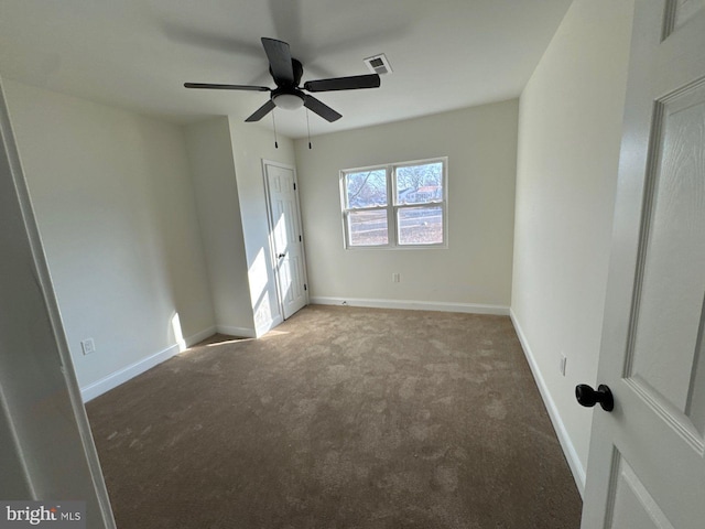 unfurnished bedroom with carpet floors, baseboards, visible vents, and ceiling fan