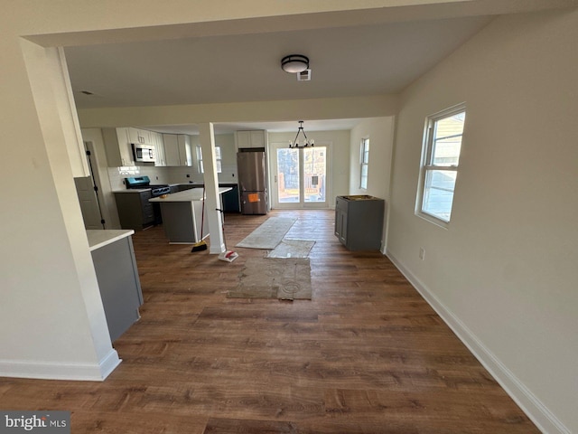 interior space with dark wood-style floors and baseboards