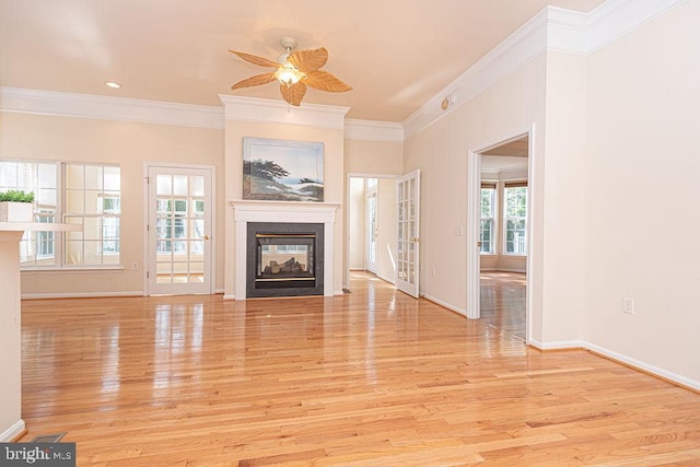 unfurnished living room with baseboards, ceiling fan, crown molding, light wood-style floors, and a multi sided fireplace