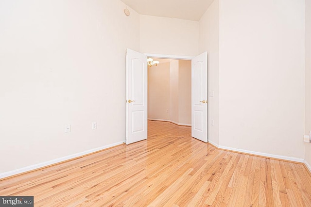 unfurnished room with wood finished floors and baseboards