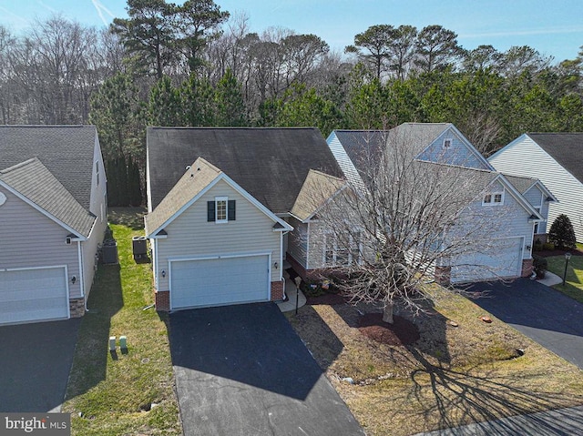 traditional-style house featuring a garage and driveway