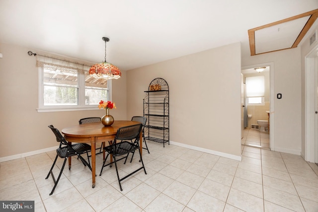 dining room featuring light tile patterned flooring, visible vents, and baseboards