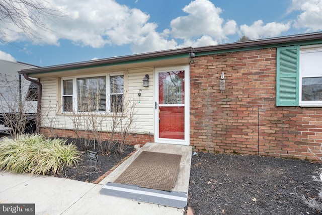 property entrance featuring brick siding