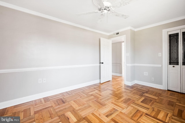 unfurnished room featuring visible vents, crown molding, and baseboards