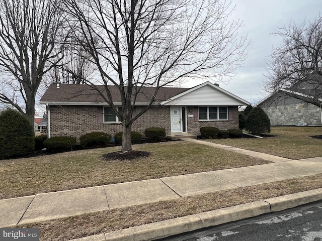 ranch-style home with brick siding and a front lawn