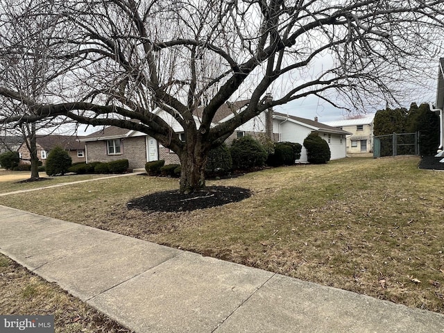 view of front facade with brick siding and a front yard