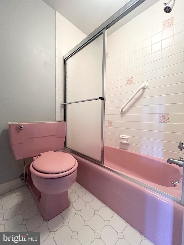 bathroom with enclosed tub / shower combo, toilet, and tile patterned floors