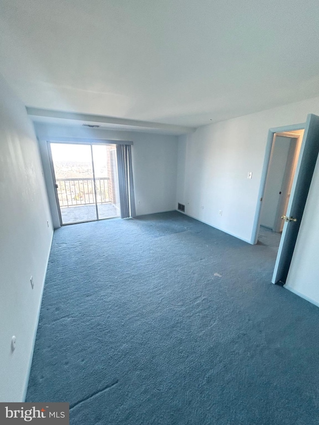 carpeted empty room featuring visible vents