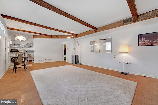 living room featuring visible vents, baseboards, and beamed ceiling