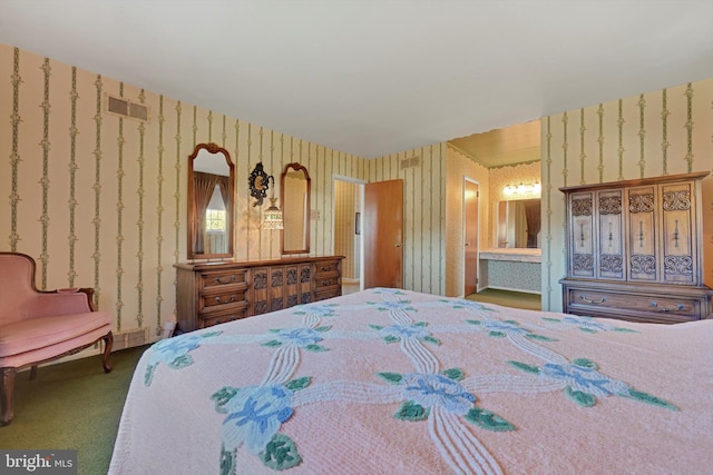 carpeted bedroom featuring visible vents, ensuite bath, and wallpapered walls