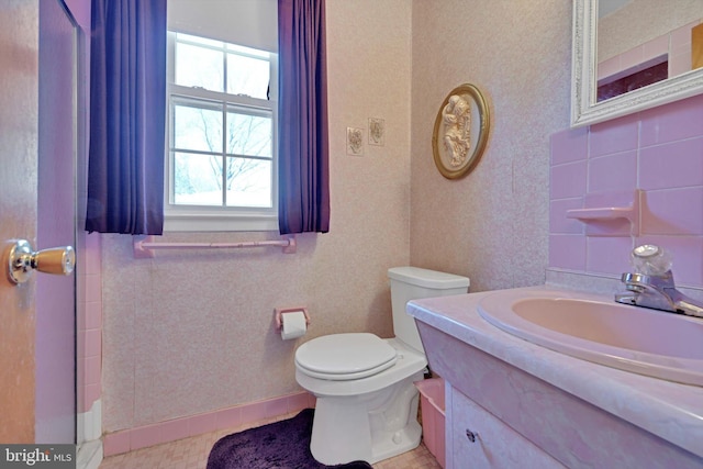 full bathroom with toilet and vanity