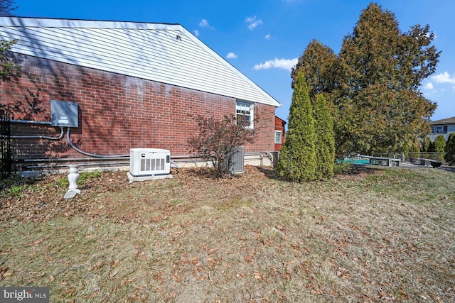 view of home's exterior with a yard and brick siding