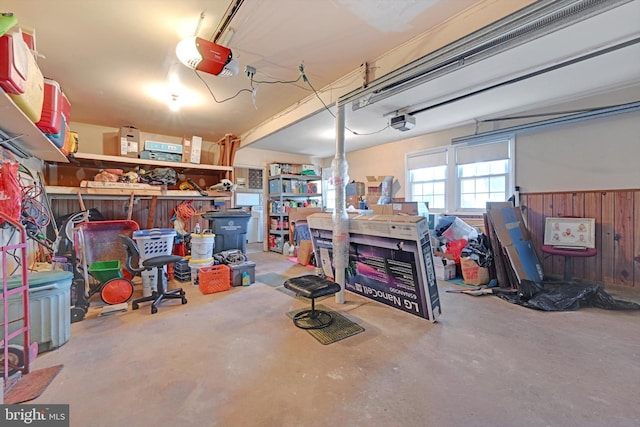 garage featuring wooden walls and a garage door opener