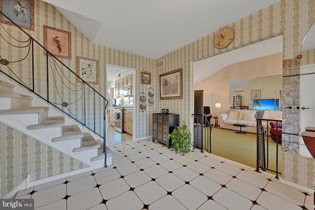 foyer entrance featuring tile patterned floors, visible vents, baseboards, and wallpapered walls