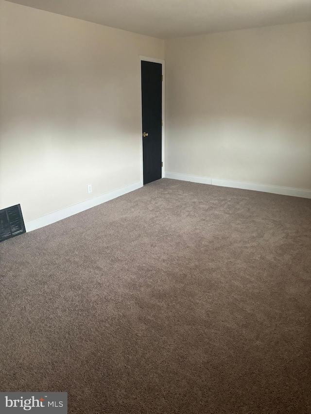 unfurnished room featuring carpet floors, baseboards, and visible vents