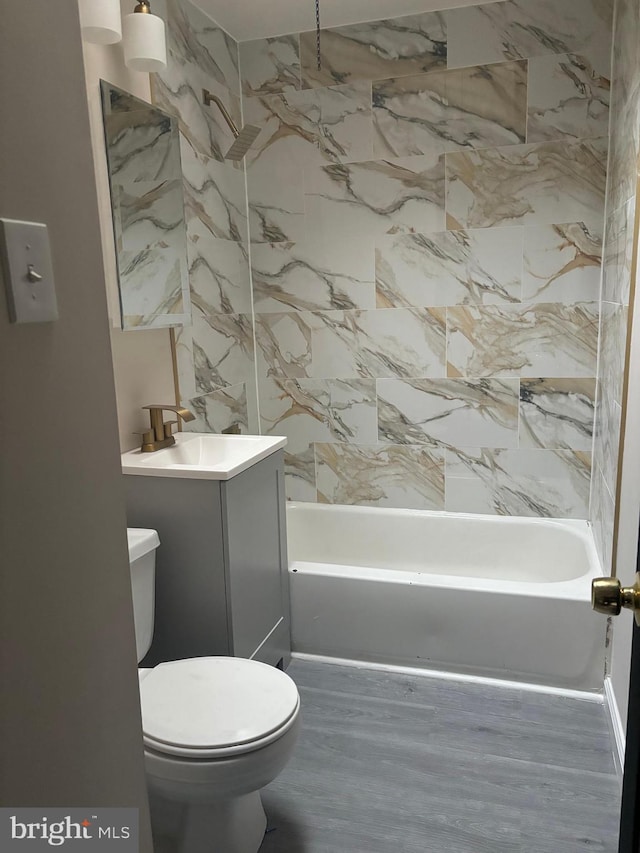 bathroom featuring tub / shower combination, vanity, and toilet