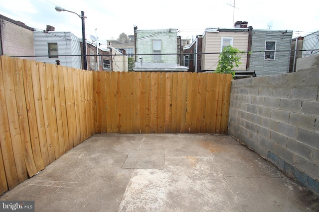 view of patio featuring fence