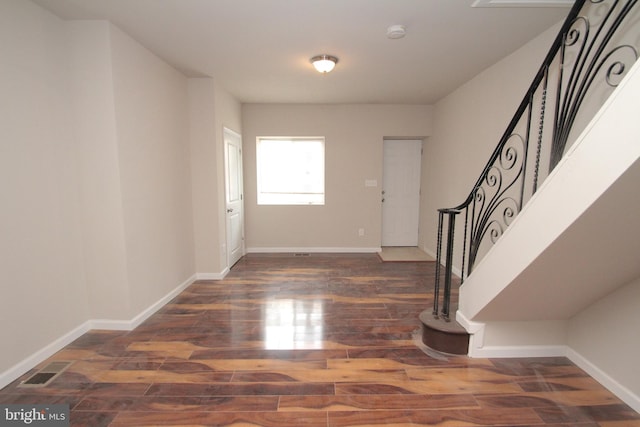 entrance foyer with stairs, wood finished floors, baseboards, and visible vents