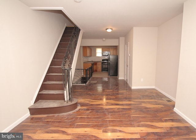 interior space featuring baseboards and wood finished floors