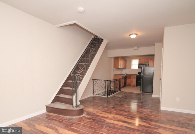 interior space featuring baseboards and wood finished floors