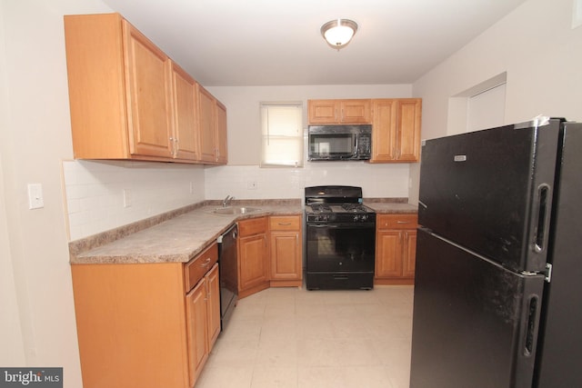 kitchen with black appliances, light countertops, backsplash, and a sink