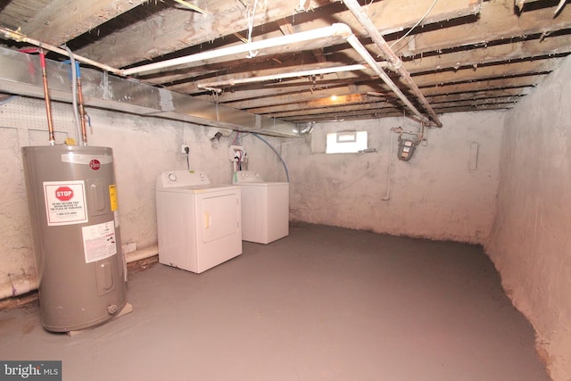 below grade area featuring washer and clothes dryer and electric water heater