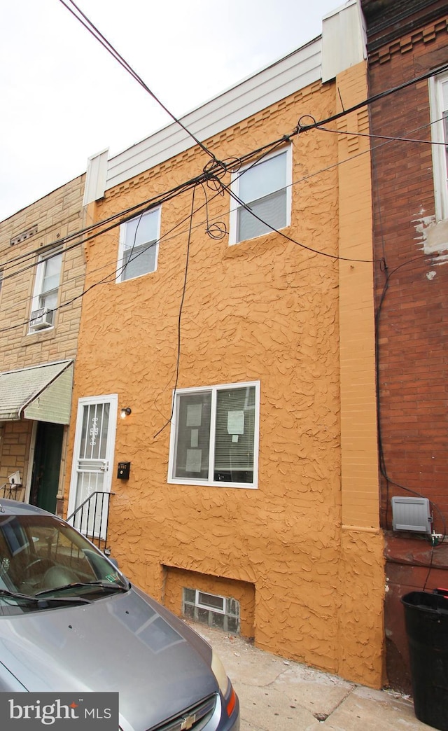 view of side of property with stucco siding