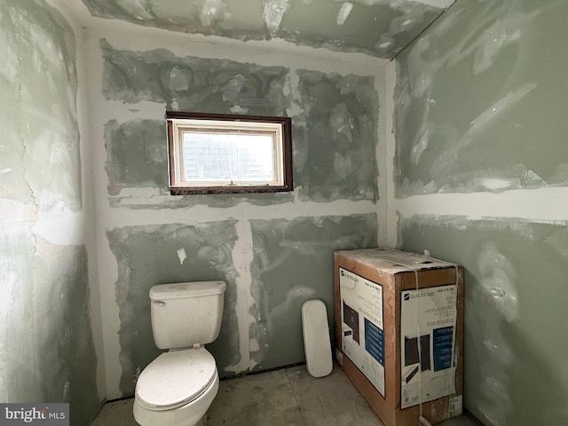 bathroom with heating unit and toilet