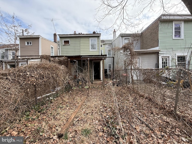 rear view of property with fence