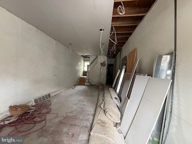 interior space featuring unfinished concrete flooring and visible vents