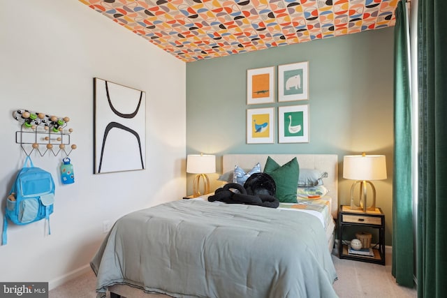 bedroom with carpet floors, brick ceiling, and baseboards