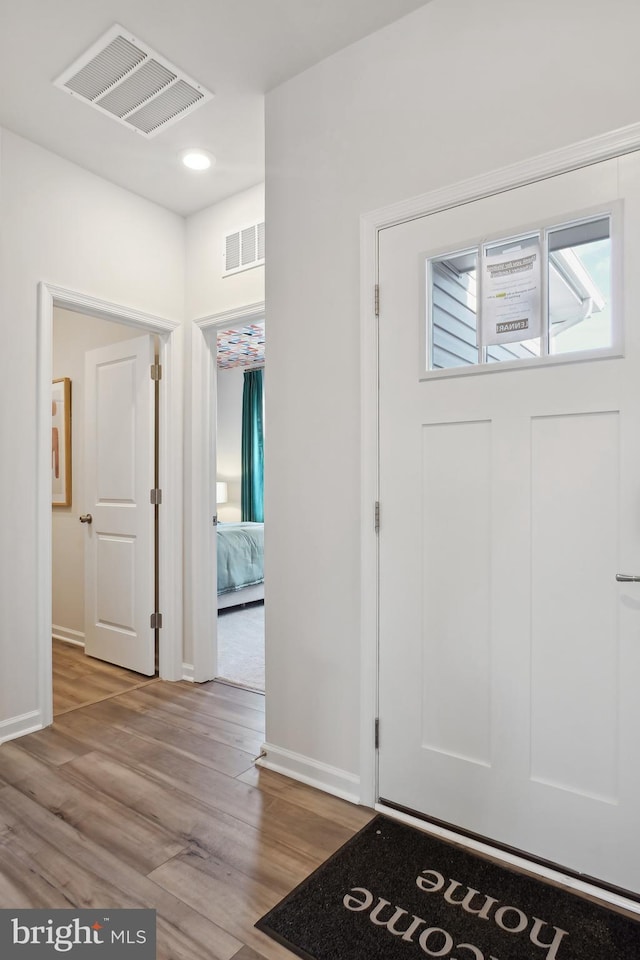 entrance foyer with light wood finished floors, recessed lighting, visible vents, and baseboards