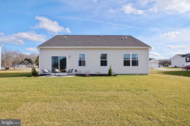 back of house with a patio area, a lawn, and roof with shingles