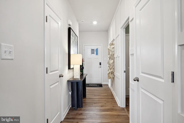 corridor with recessed lighting, baseboards, and wood finished floors