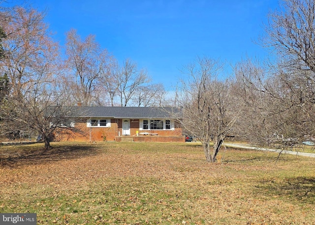 ranch-style home with brick siding and a front lawn