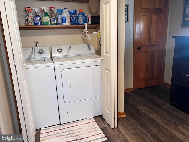 laundry area featuring laundry area, baseboards, dark wood-type flooring, and washing machine and clothes dryer