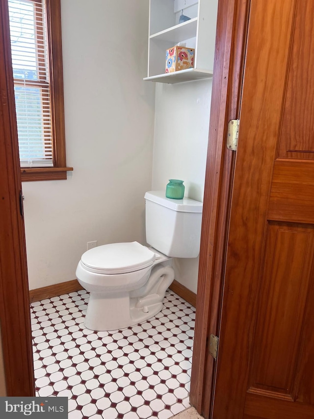 bathroom featuring baseboards, toilet, and tile patterned floors