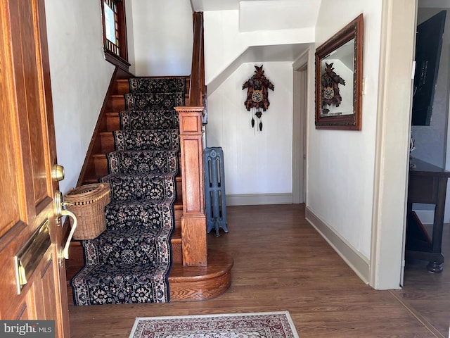 interior space featuring baseboards and wood finished floors