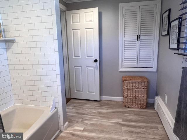 full bathroom with bathtub / shower combination, wood finished floors, and baseboards