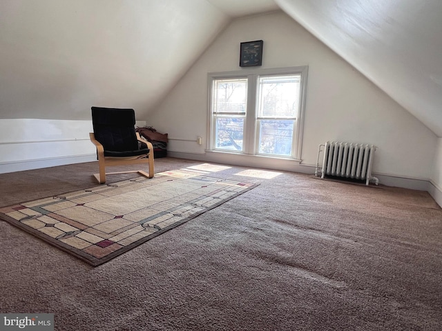 additional living space with vaulted ceiling, baseboards, carpet flooring, and radiator