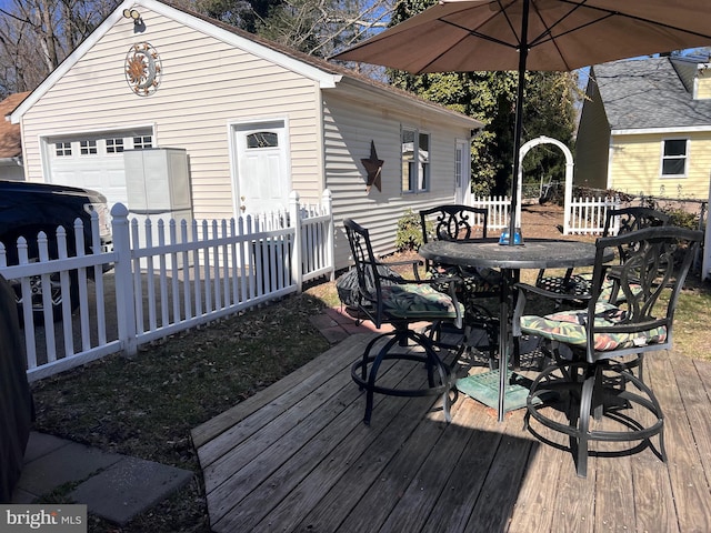 deck with outdoor dining area and fence