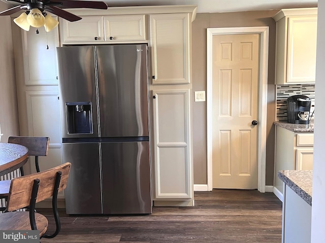 kitchen featuring dark wood-style floors, decorative backsplash, light countertops, and stainless steel fridge with ice dispenser