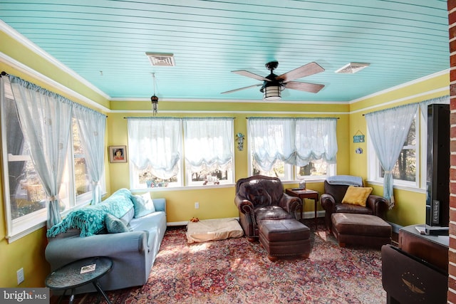 sunroom featuring visible vents and a ceiling fan