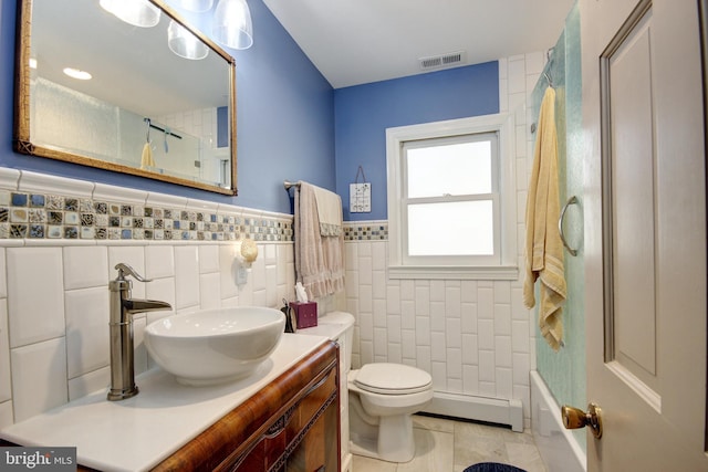 bathroom featuring visible vents, toilet, tile patterned flooring, vanity, and a baseboard heating unit