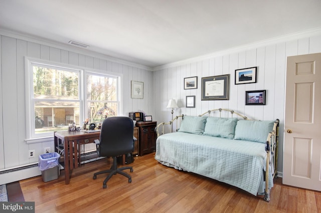 bedroom featuring visible vents, wood finished floors, and ornamental molding