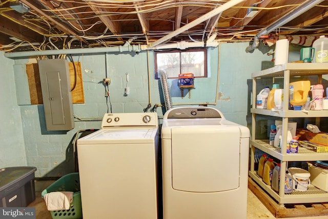 washroom featuring laundry area, separate washer and dryer, and electric panel