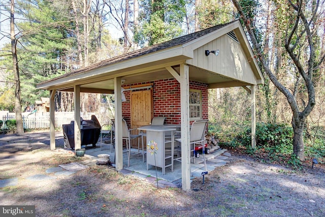 view of patio / terrace featuring area for grilling and fence